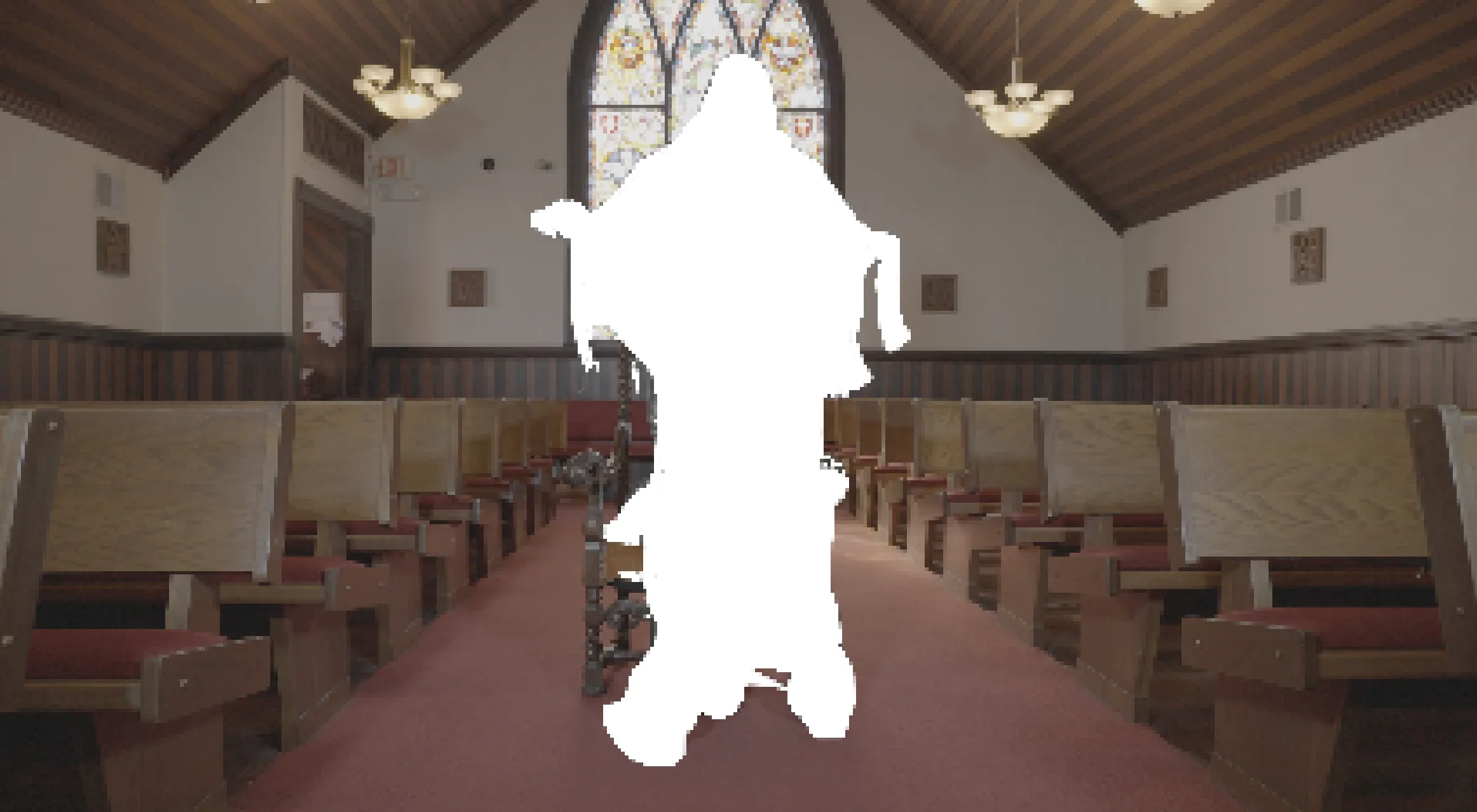 The nave of a church. In the center, a vaguely spirit-like figure appears to have been cut out of the photo, obscuring a single chair in the center aisle.